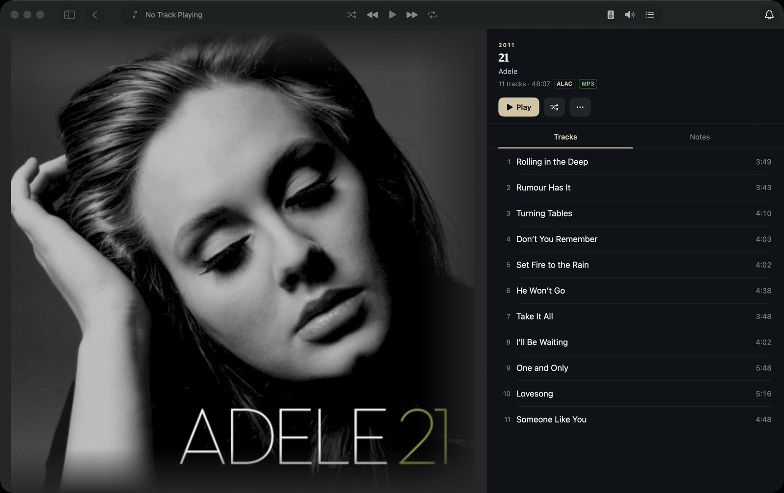 An album open on the Mac: full-size artwork on the left, track list with durations on the right, Play and Shuffle buttons, and format badges.