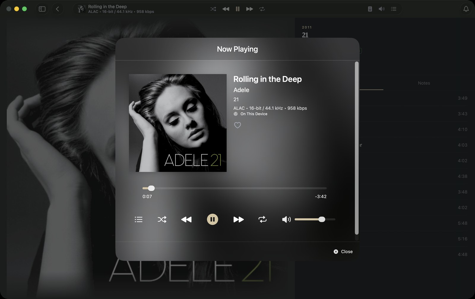The Now Playing window on the Mac: large artwork, track, artist and album, the audio format, a scrubber, transport controls and volume.