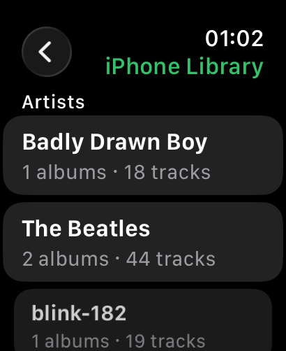 Browsing the iPhone library from the Watch: an artist list with album and track counts.
